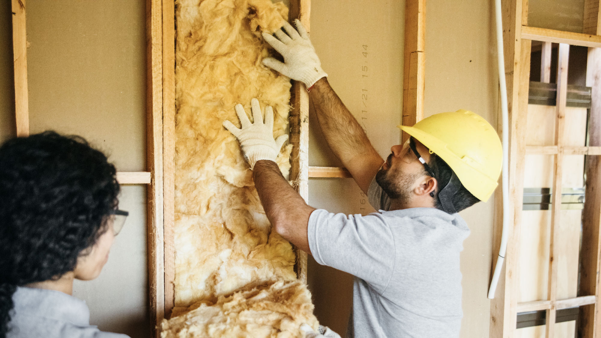 man installing insulation